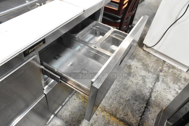 Delfield stainless steel commercial sandwich salad prep table with Bain Marie mega top, four drawers, and overshelf. 115 volts, 1 phase.