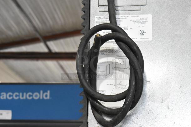 Manitowoc SY1805W stainless steel commercial ice head on bin. Visible wiring and label with model details. 208-230V, 1 Phase.