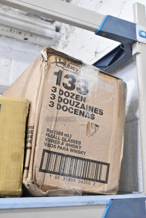 Box of Libbey 133 Heavy Base 9 oz. Highball Glasses, marked with "3 Dozen" in multiple languages. Slight wear visible.