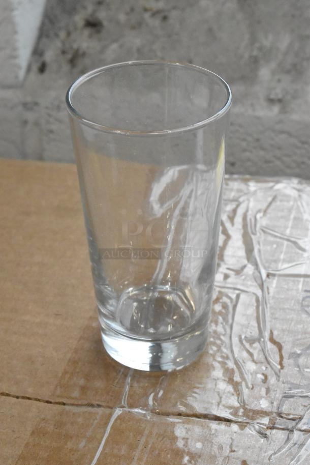 Clear glass tumbler on a cardboard surface; part of a new auction offering including G.E.T. 9910-1-BL and Libbey 133 glasses.