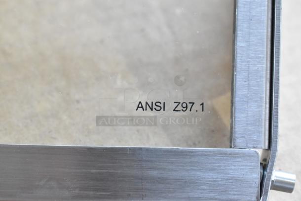 "Brand new metal access door for conveyor pizza oven, scratch and dent condition, shows ANSI Z97.1 marking."
