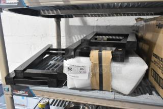 Lot of black wooden pieces, brand new with minor scratches and dents. Includes inventory tag labeled "86 QTY V-lot."