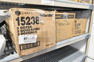 Boxes of glassware: Libbey Gibraltar 12 oz. glasses, Acopa Select Flora 19 oz. wine glasses, Libbey Lexington 10.25 oz. rocks glasses. New scratch and dent condition.