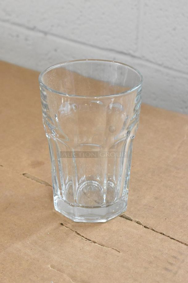 Libbey Gibraltar 12 oz. Beverage Glass, clear glass, sturdy base, new condition on a cardboard surface.