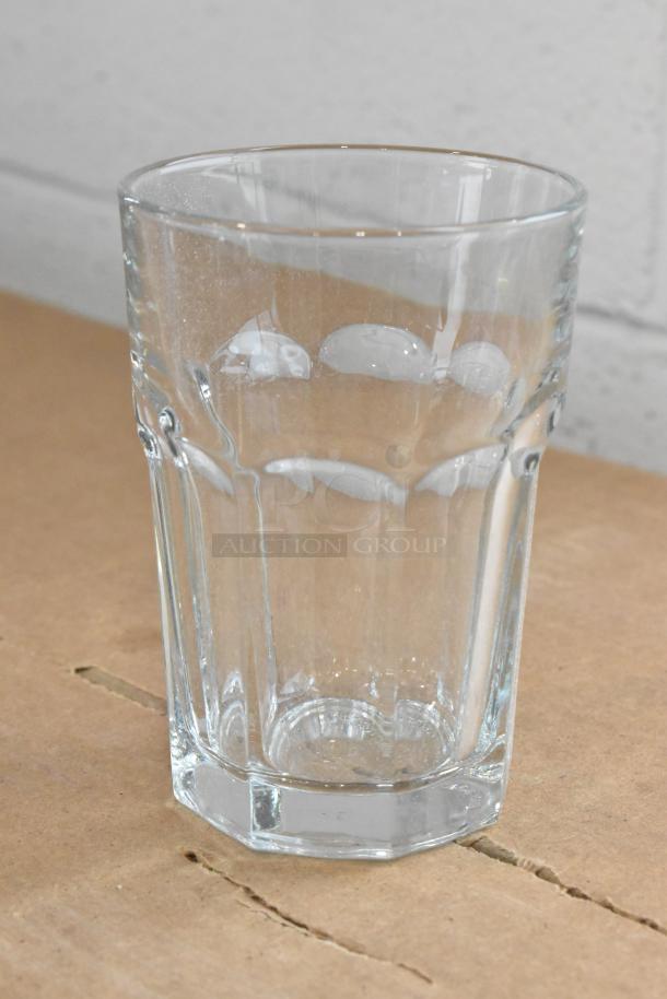 Libbey Gibraltar 12 oz. beverage glass, clear, with a textured design, resting on a cardboard surface. Brand new condition.