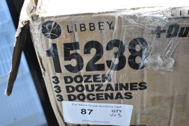 Cardboard box labeled "Libbey 15238" with "3 DOZEN" in English, French, Spanish. Box is taped and slightly worn.