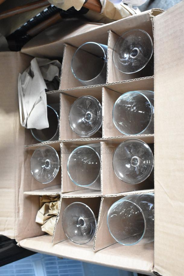 Box of new glasses, including Libbey Gibraltar 12 oz. and Lexington 10.25 oz. glasses, Acopa Select Flora 19 oz. wine glasses.