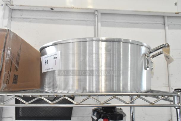 Brand new Town 34616 18 Qt. aluminum steamer water pan showing minor scratches. Features sturdy handles and auction label.