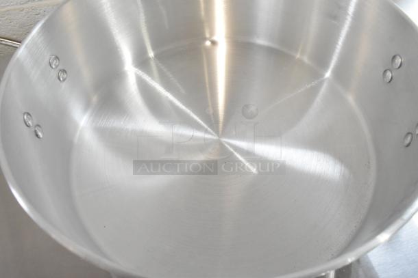 Brand new Town 34616 18 Qt. aluminum steamer water pan, shows minor scratches and dents, shiny metal surface.