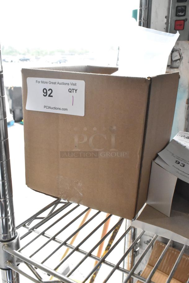 Cardboard box containing a brand new scratch and dent monitor. Visible label reads "92 QTY 1, PCIAuctions.com."