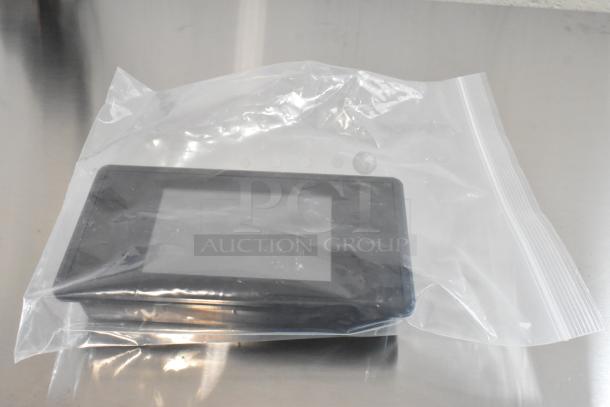 Brand new monitor in plastic packaging, labeled as "scratch and dent" condition.