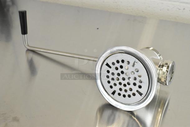 Stainless steel drain with lever handle, brand new condition with minor scratches and dents, chrome finish, durable design.