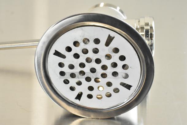 Stainless steel drain strainer with round holes, slight scratches and dents, new condition, polished finish.