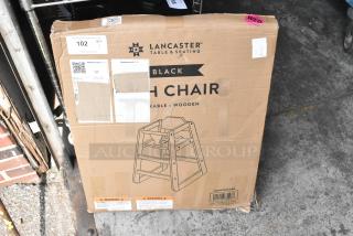Brand new Lancaster wooden high chair, black finish, model 164WHCKDBK, unassembled, in original packaging.