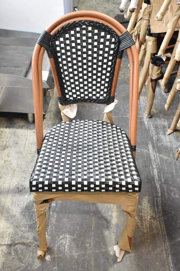 Lancaster Table & Seating 427CSRTBSBKW Bistro chair, black/white checkered weave, rattan frame, new, scratch and dent condition.