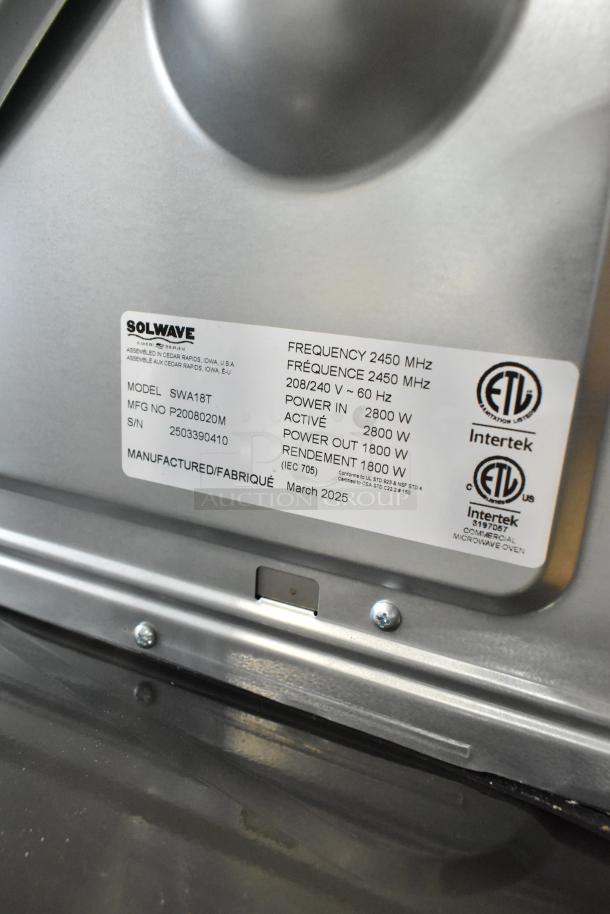 Brand new Solwave SWA18T Ameri-Series stainless steel commercial microwave, 208/240V, label showing model and specs.