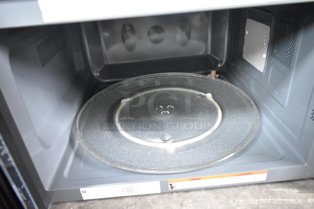 Brand new General Electric GE PCST22U1W1SS microwave oven with scratch and dent. Includes glass plate. 2025 model.