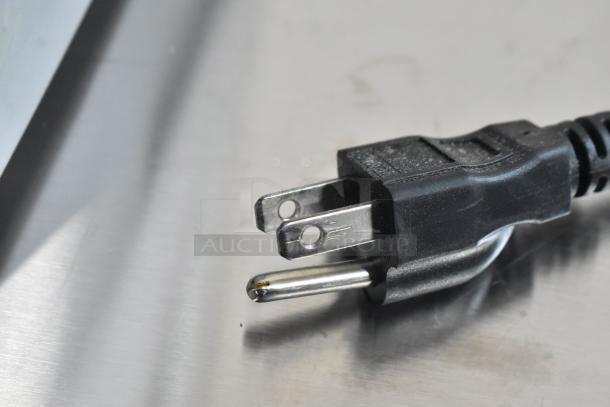 Close-up of the power plug for a Robot Coupe Blixer 4 food processor, showing standard three-prong design.