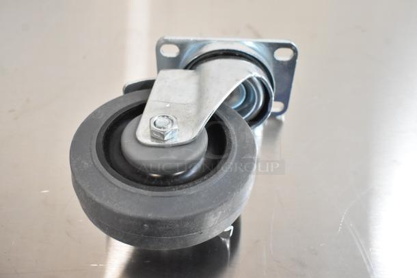 Brand new scratch and dent commercial caster, features durable wheel, metal bracket, bolt, and some visible surface marks.