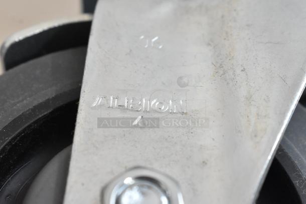 Lot of 4 commercial casters, Albion brand, new with scratches and dents, robust design, visible markings.