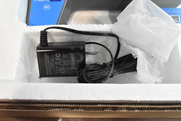 Brand new AvaTek 334RSB50SS digital scale in box with visible power supply and packaging. Built-in handle, 50 lb. capacity.