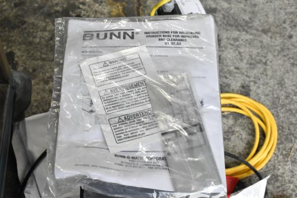 Bunn G1 HD coffee grinder instructions, visible warnings, and branding, showing included documentation.