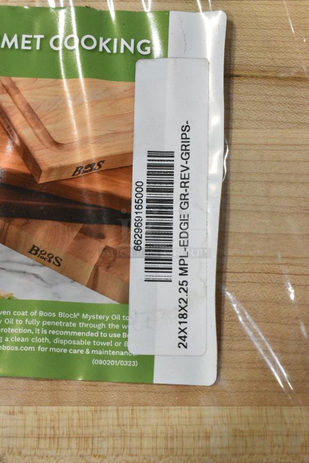 Brand new John Boos & Co. RA03 24" x 18" reversible maple cutting board with hand grips; minor scratches; barcode visible.