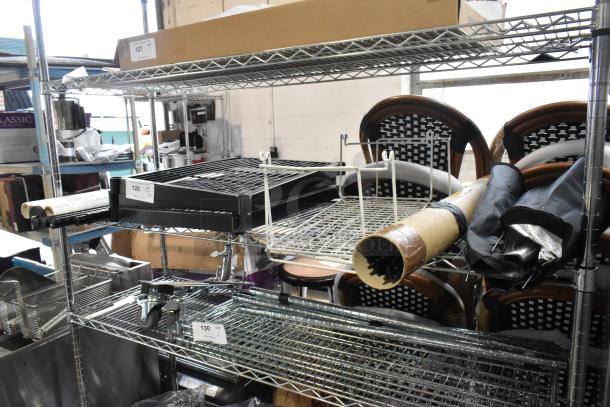 Auction lot of various items including Westcott Basics and ERIGEA055 umbrella with holder, displayed on shelving.