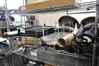 Auction lot of various items including Westcott Basics and ERIGEA055 umbrella with holder, displayed on shelving.