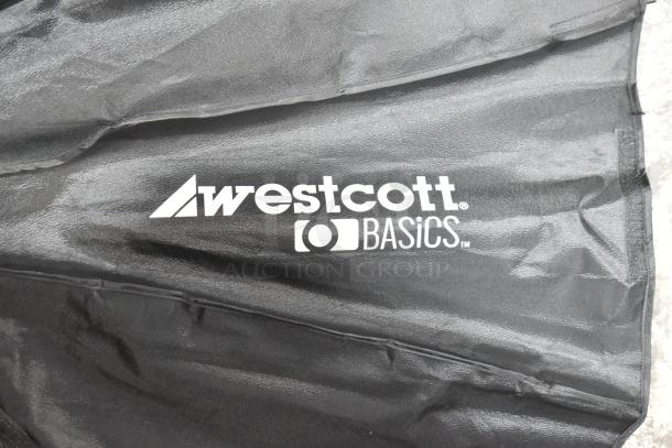 Westcott Basics black umbrella with visible logo, part of a mixed auction lot, condition appears intact.