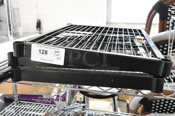 Tiered metal shelving unit with black and chrome finish, labeled lot 128. Includes various items, condition unspecified.