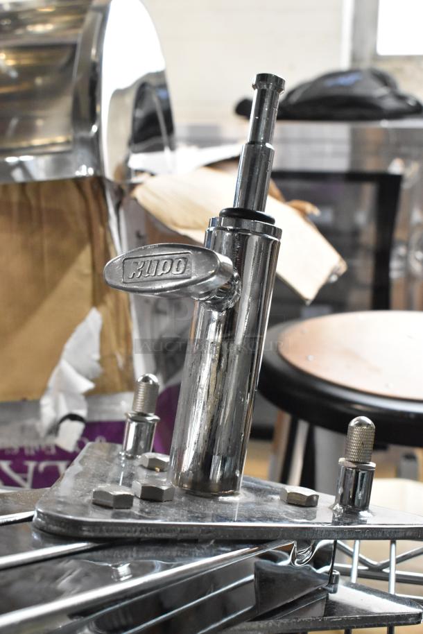 Kupo Commercial Casters, chrome finish, featuring a sturdy metal construction with adjustable components, brand logo visible.