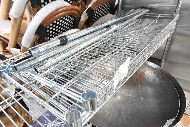 Metal wire shelves and poles in good condition, bundled for auction. Includes mesh grid design and sturdy poles for assembly.