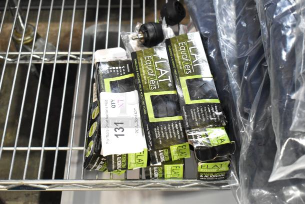 7 brand new Flat Table Equalizers in packaging, labeled for stabilizing tables. Auction tag indicates lot number 131.