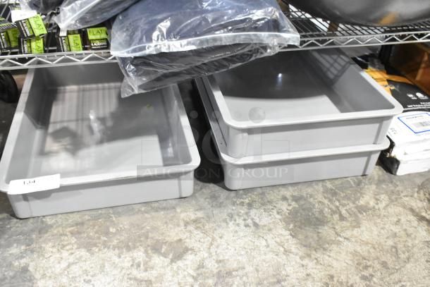 Three gray poly dough bins, brand new, scratch and dent condition, stacked on a shelf.