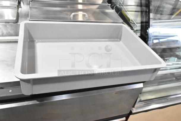 Gray poly dough bin, new, with minor scratches and dents, on a metallic surface. Part of a set of three.