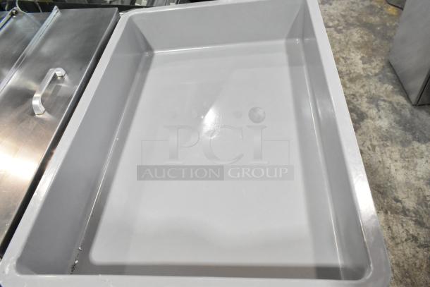 Gray poly dough bin with minor scratches and dents, brand new condition. Durable, ideal for food storage.