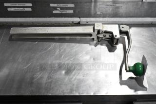 Brand new Garde 407 metal commercial can opener, scratch and dent condition, with green handle on metal countertop.