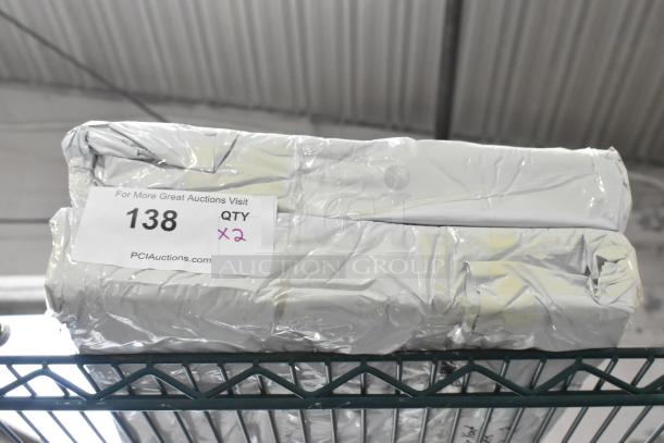 Two brand new scratch and dent air vent covers wrapped in silver packaging, labeled "Qty x2, 138" from PCAuctions.com.