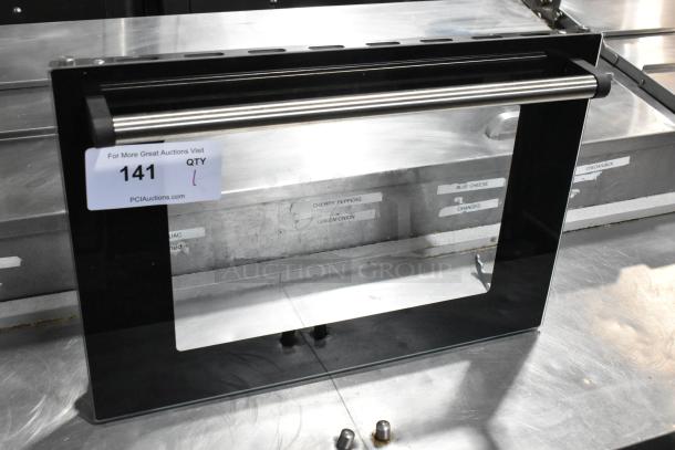 Brand new metal oven door, labeled "Scratch and Dent." Features stainless handle, black frame. Auction tag: 141 QTY 1.