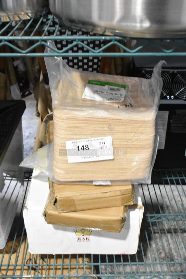 4 brand new scratch and dent items including EcoChoice 9" compostable bamboo plates, Plaza trays, RAK porcelain plates. Qty 4.