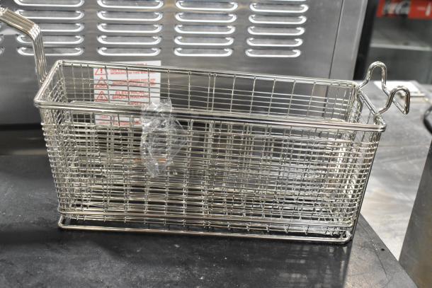 Brand new metal fry basket with slight scratches and dents. Rectangular wire mesh design, hooked handle, wrapped in plastic.