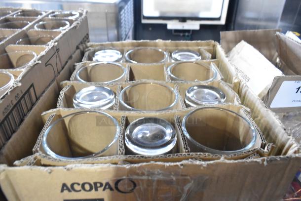 Box containing brand new Acopa Select 14 oz. stackable glasses, visible scratch and dent, packed in cardboard.