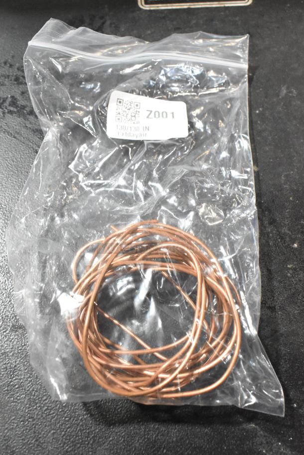 Brand new copper colored wire coil in sealed plastic bag with label "Z001".