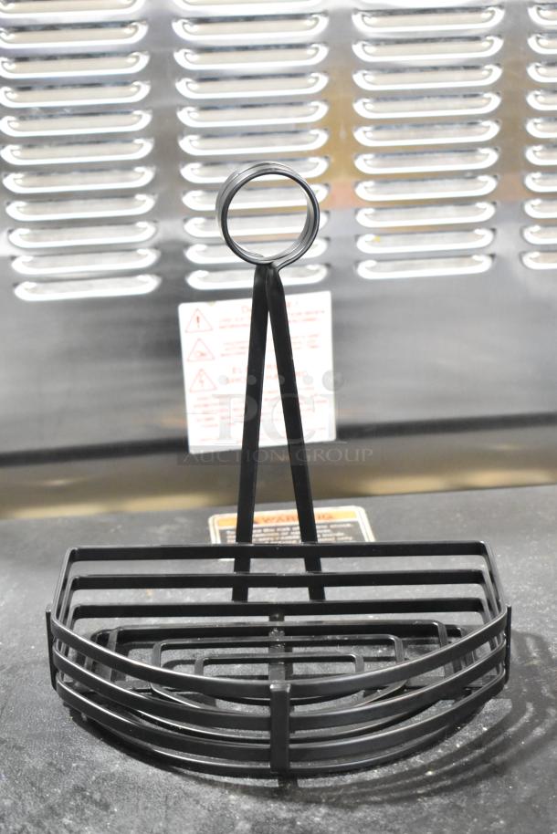 Brand new black metal countertop holder, minor scratches, semicircular design, durable construction, ideal for organizing.