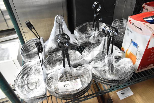 11 black metal countertop holders, brand new, wrapped in plastic. Minor scratches and dents. Quantity label: "QTY x11".