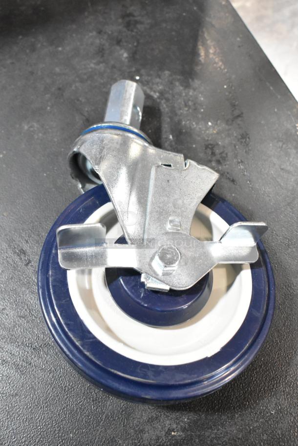 Brand new, scratch and dent commercial caster with blue rubber wheel and metal bracket on a black surface.
