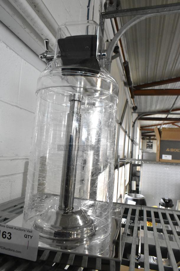 Brand new clear dispenser with minor scratches and dents. Features chrome handle, metal base, and plastic container.