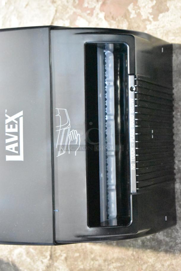 Brand new Lavex black poly wall mount paper towel dispenser, "scratch and dent" condition. No-touch operation instructions visible.