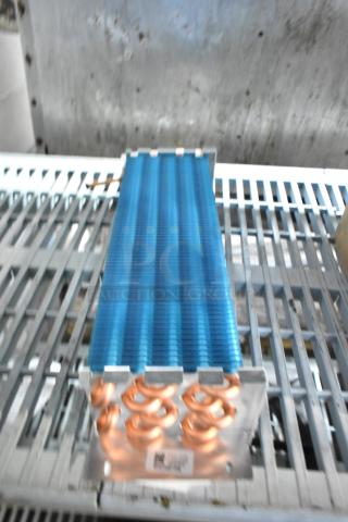 Brand new Avantco 17815282HC evaporator coil for A-12 refrigerators, featuring copper coil and blue fins. Scratch and dent condition.